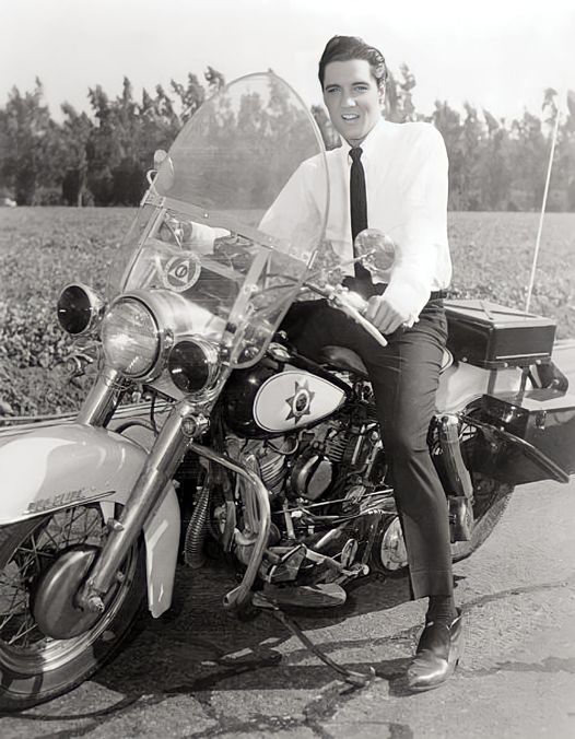 Elvis Presley on police Harley-Davidson motorcycle during movie It Happened at the World’s Fair 1963