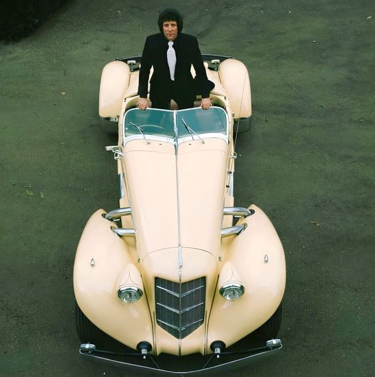 Tom Jones poses in a 1936 Auburn BoatTail Speedster